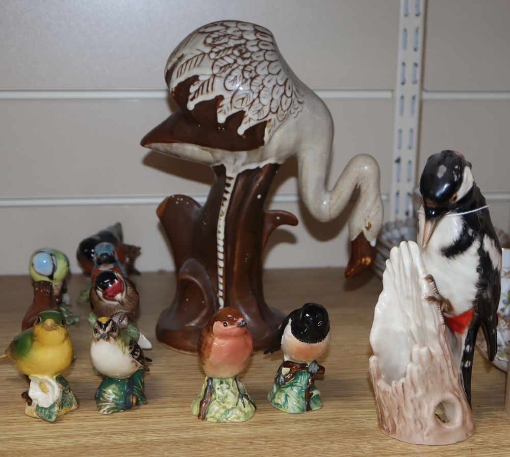 Ten Beswick birds, a David Sharp Rye pottery flamingo and a Goebel spotted woodpecker